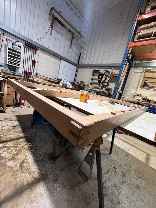 Handmade side table in native English hardwood on a workshop bench